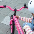 kid pressing button to power on lights on jlr 16 bike
