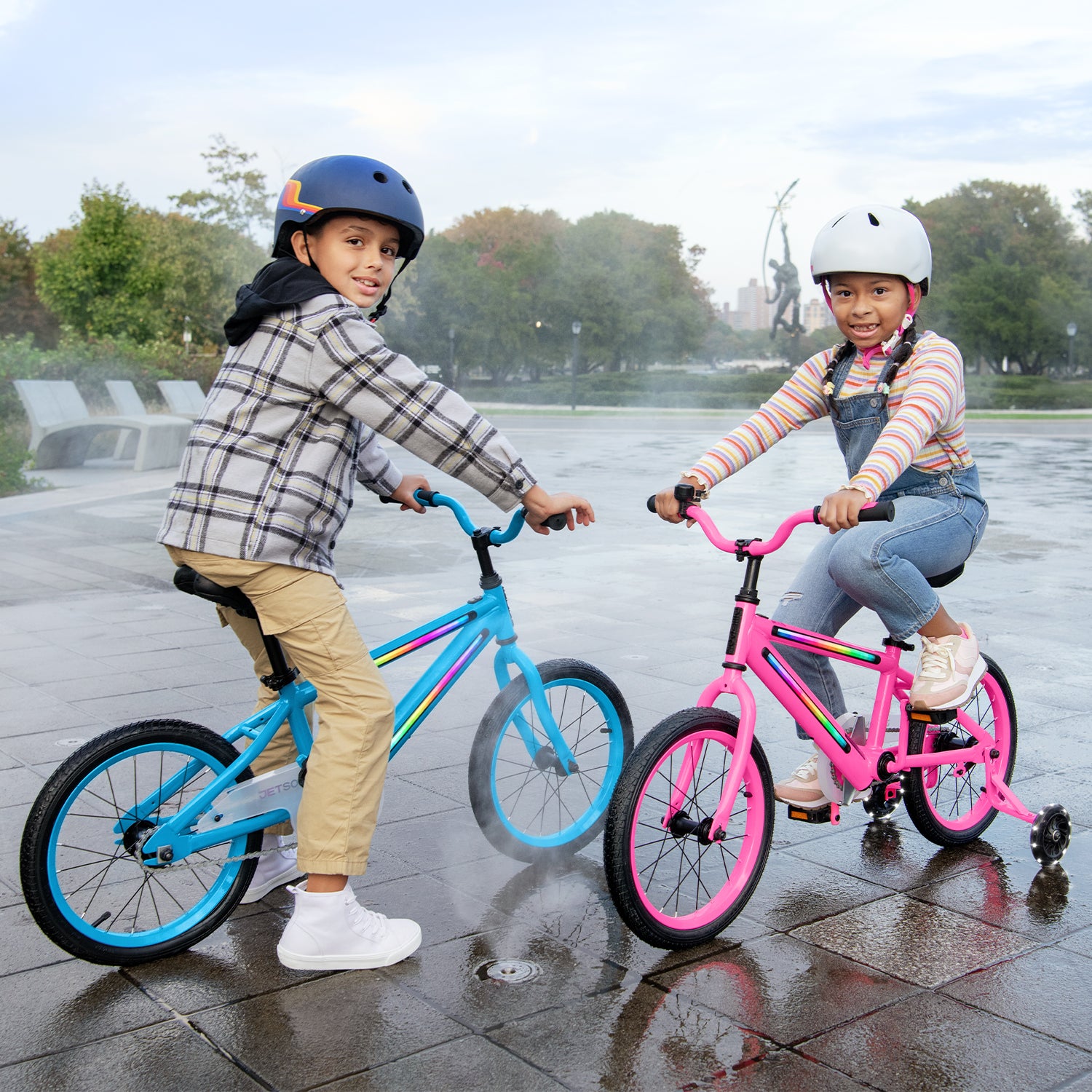 two kids riding pink and blue bikes