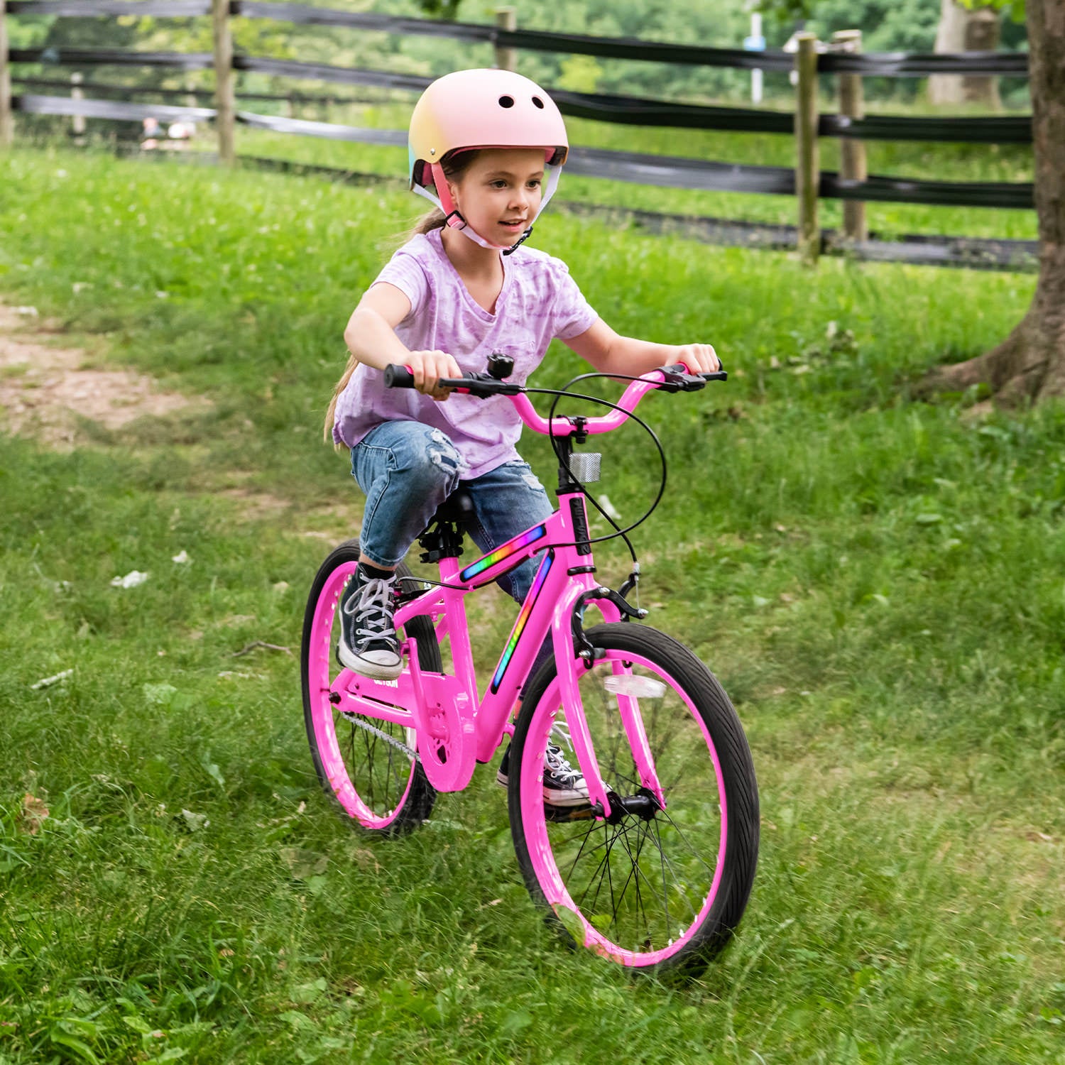 little girl riding JLR X through the grass