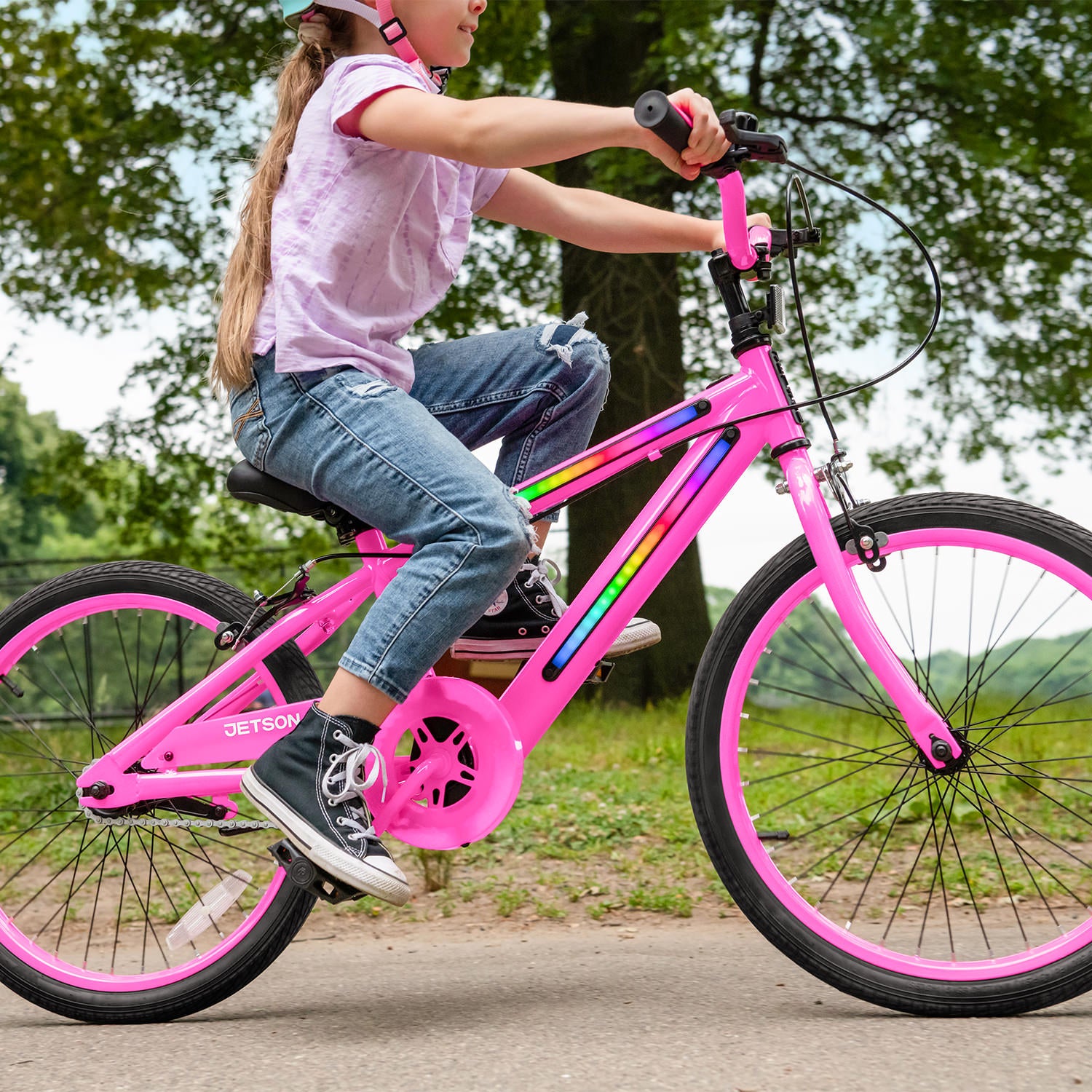 close up view of a little girl riding her JLR X through the park