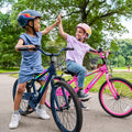 two children on their JLR X bikes high fiving each other