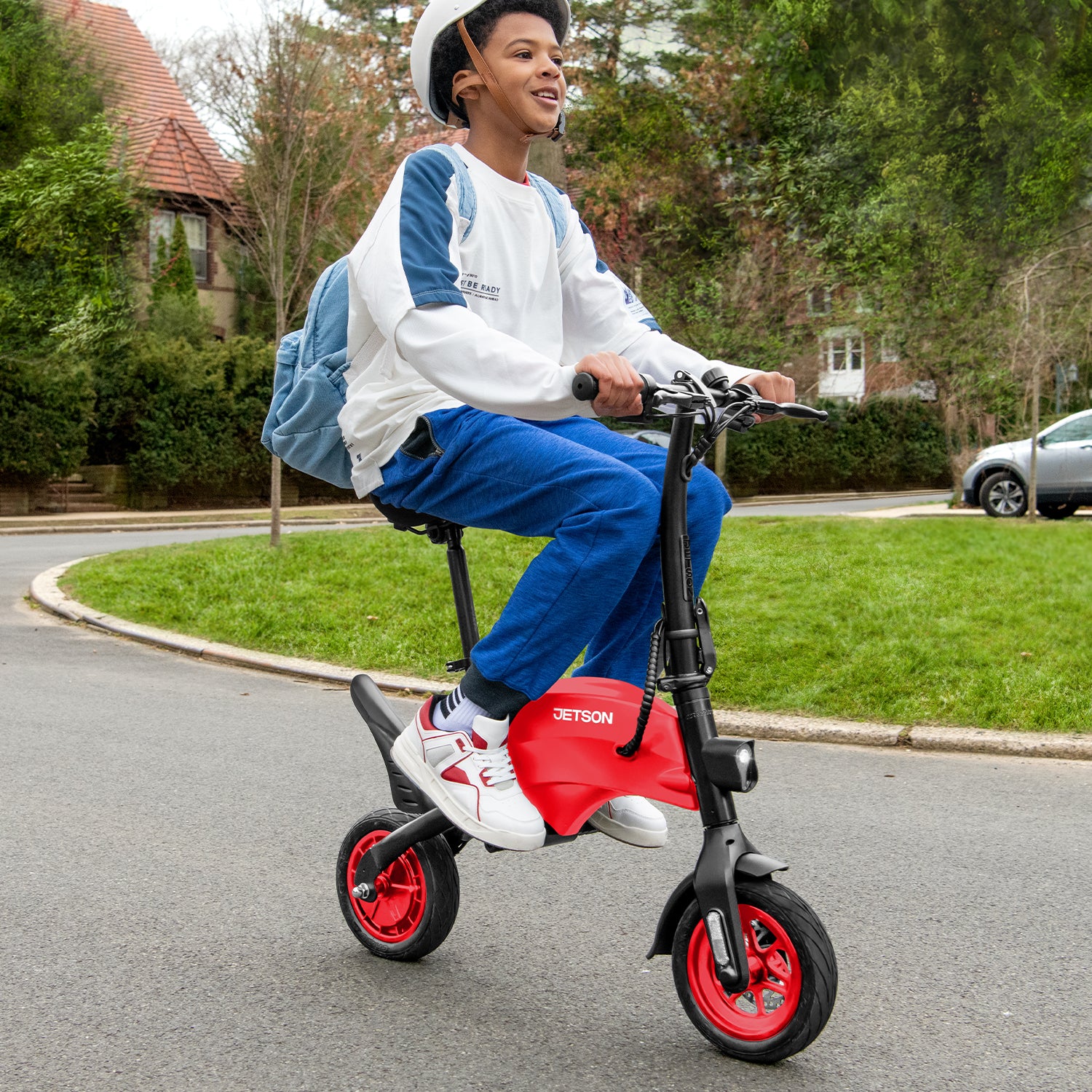 person riding the red LX10 in a neighborhood