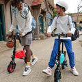 two people looking at each other, one is on their LX10, while the other is pushing it along and they are both outside