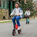 two people riding the red and blue LX10s outside on a street
