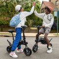 two people high fiving each other and smiling while sitting on their LX10s