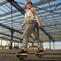 person on their MotoKicks looking back