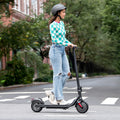 side view of person riding the e-scooter in the streets