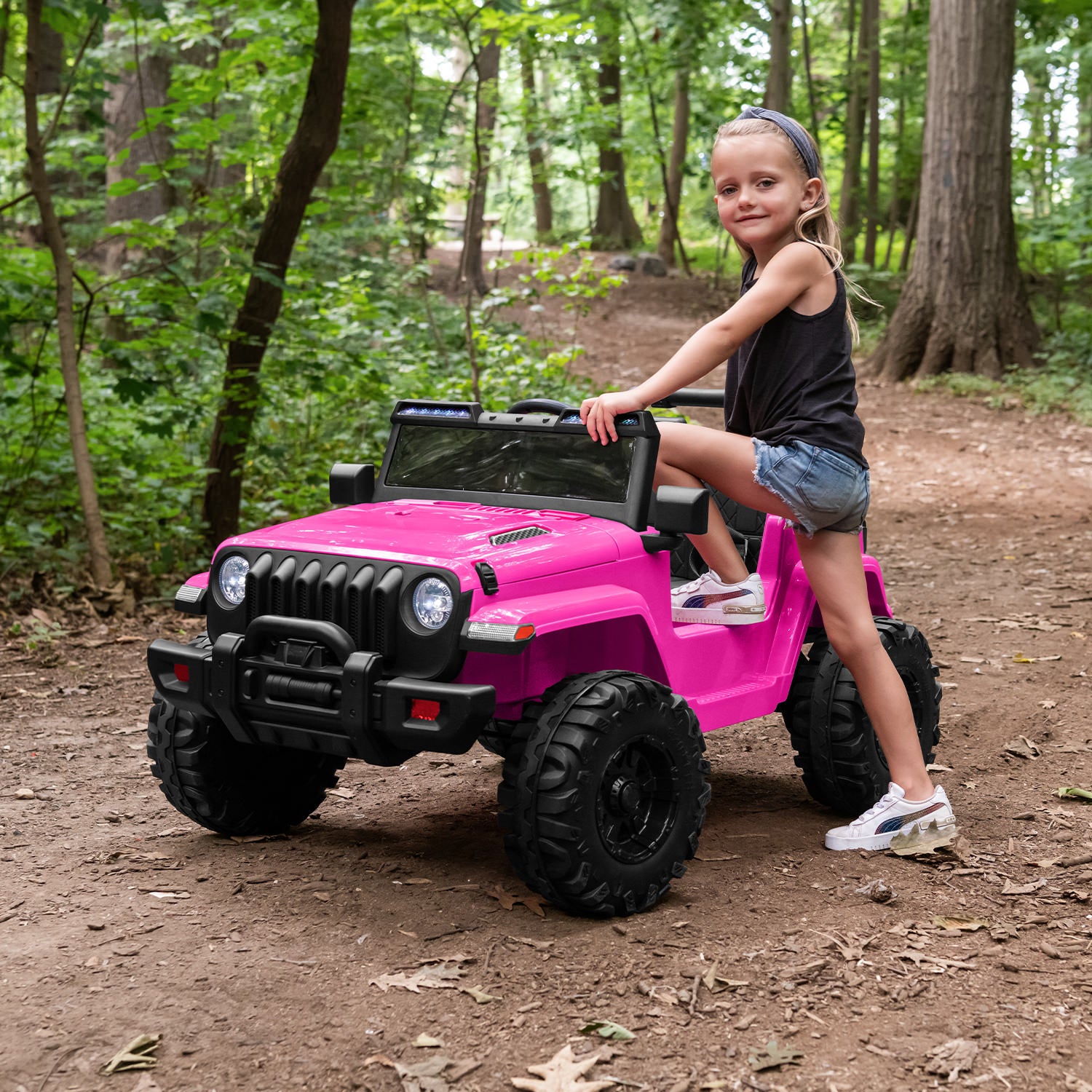 kid stepping into pink safara ride-on