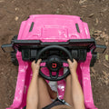 close up of hands on the steering wheel in pink safara ride-on