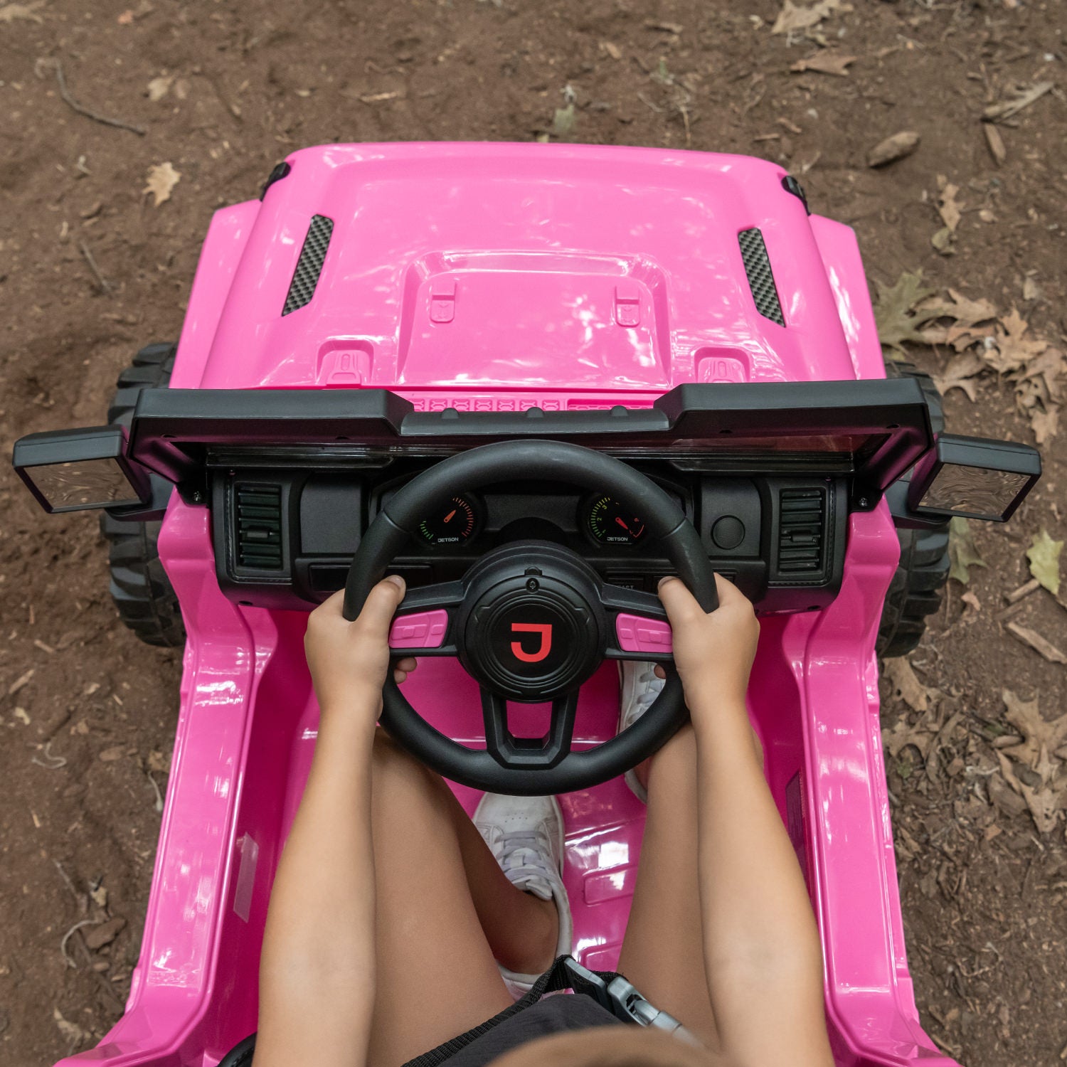close up of hands on the steering wheel in pink safara ride-on
