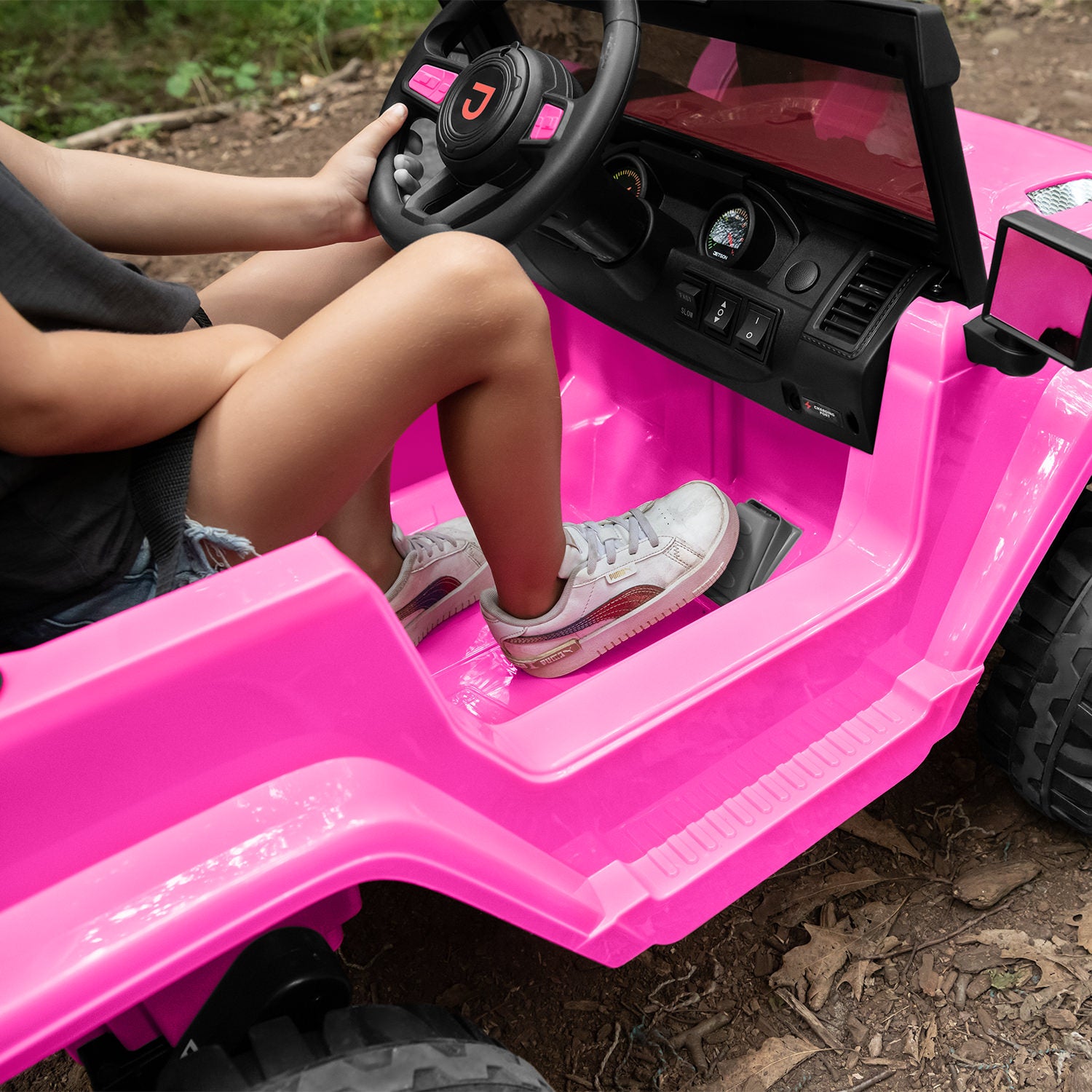 close up of foot on accelerator pedal in pink safara ride-on
