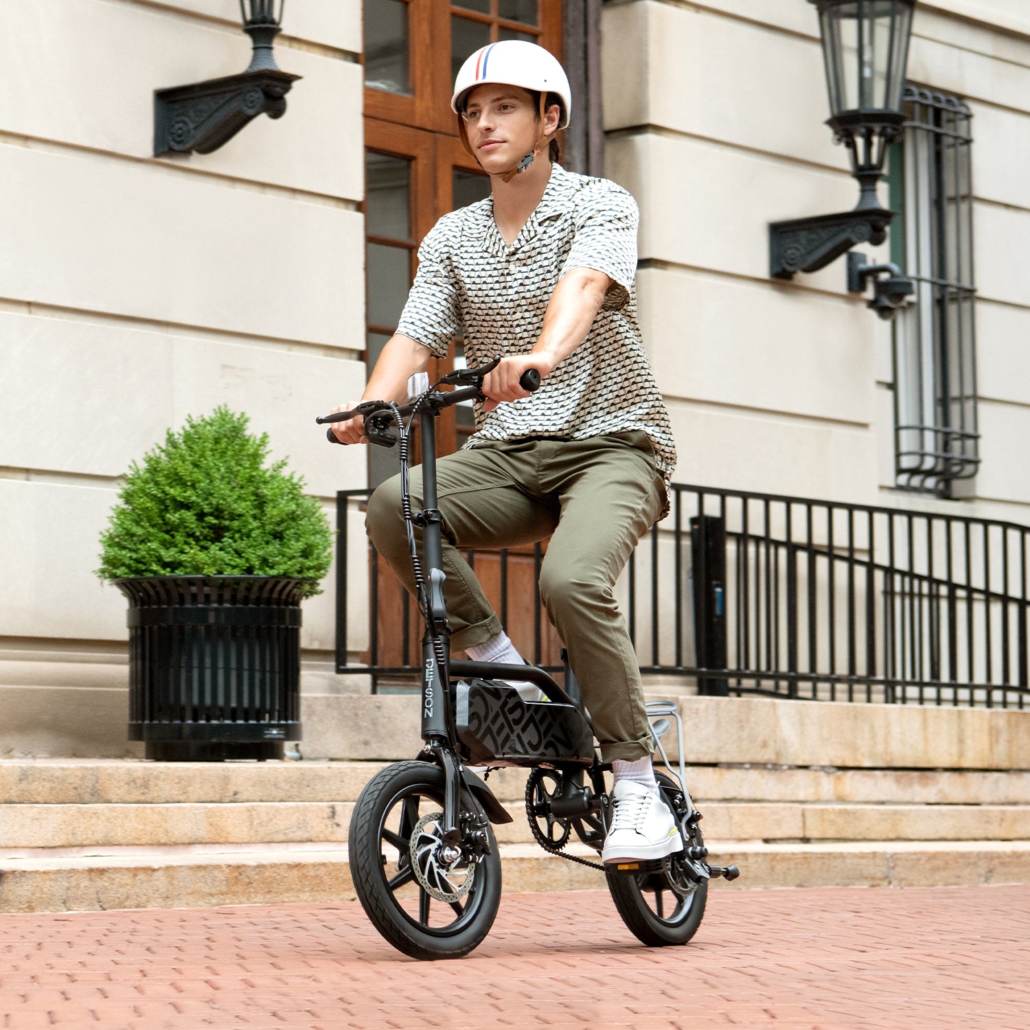 person riding j5 bike in a helmet