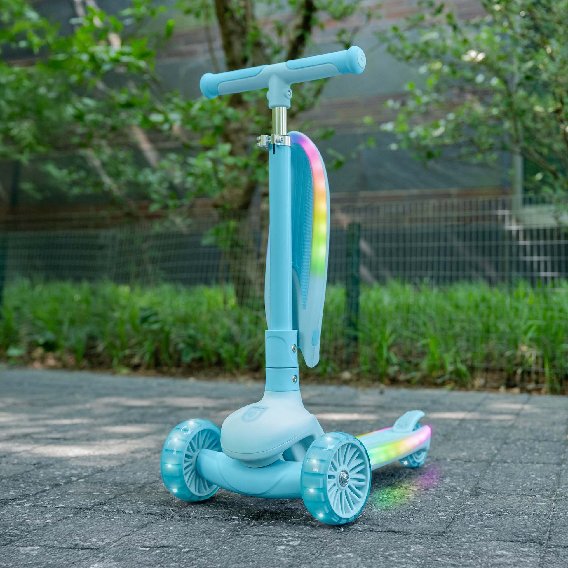 aria kick scooter outside in a park with the seat raised up