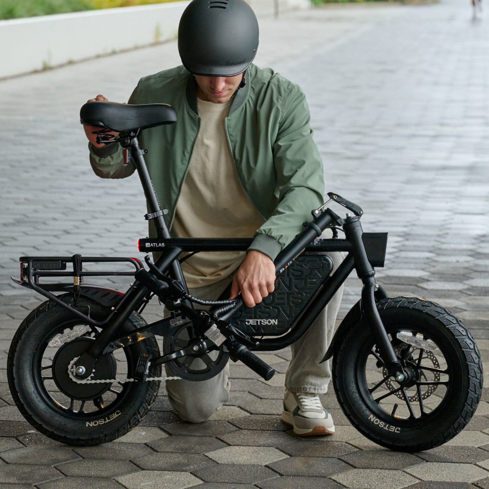 person folding handlebar down on atlas pro electric bike