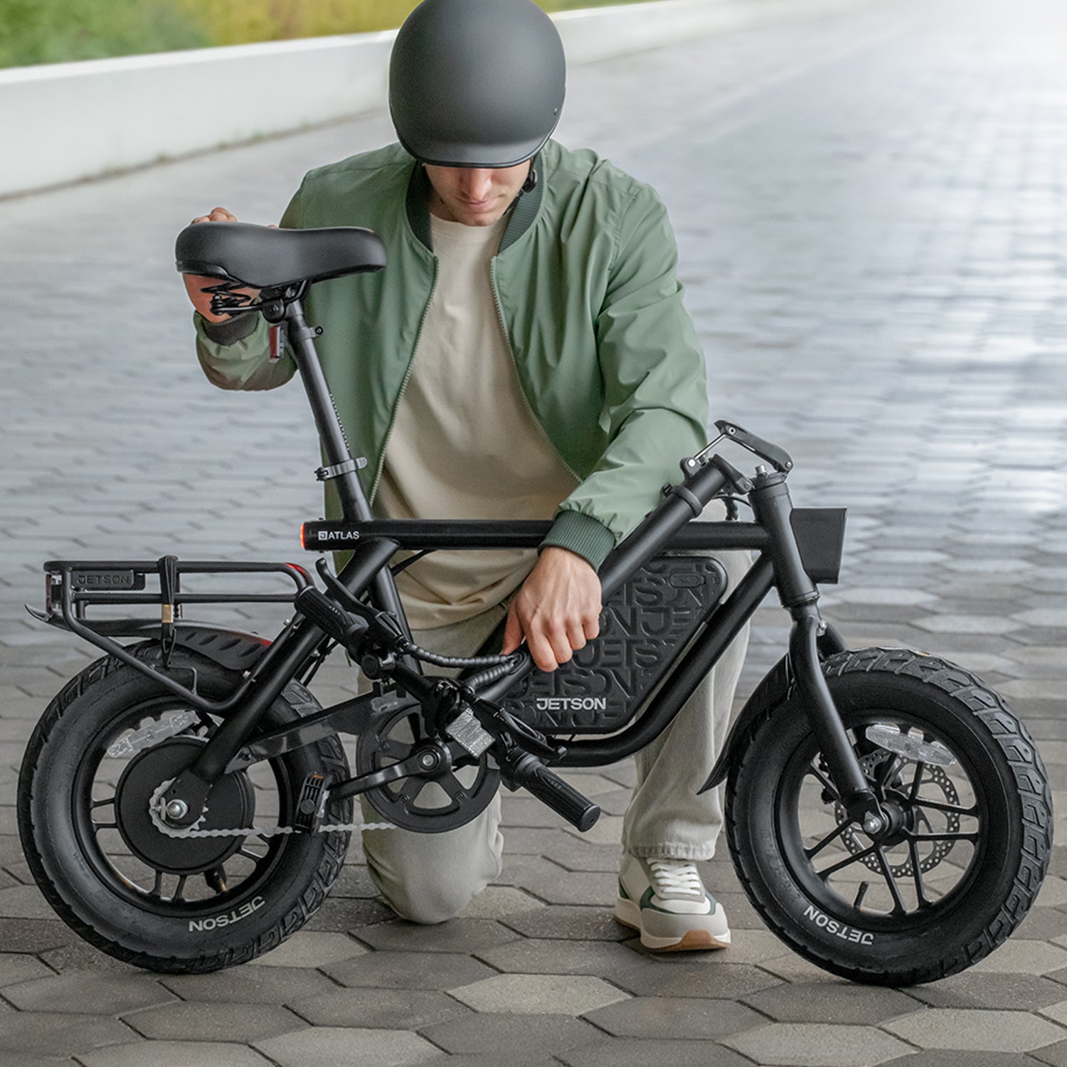 man folding handlebar on atlas pro electric bike