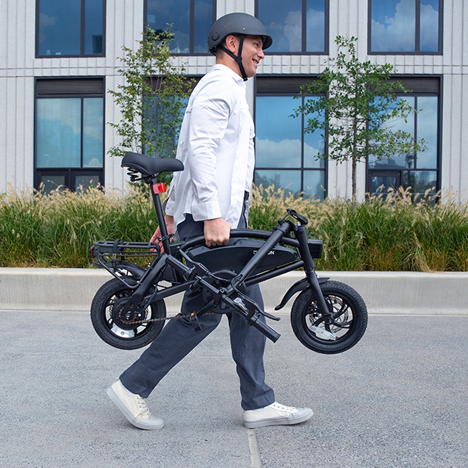 man carrying folded axle x electric bike