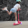 young kid riding pink bloom kick scooter