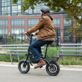 man riding bolt pro max e-bike through a park