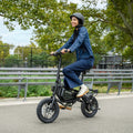 woman riding bolt pro max e-bike in a park