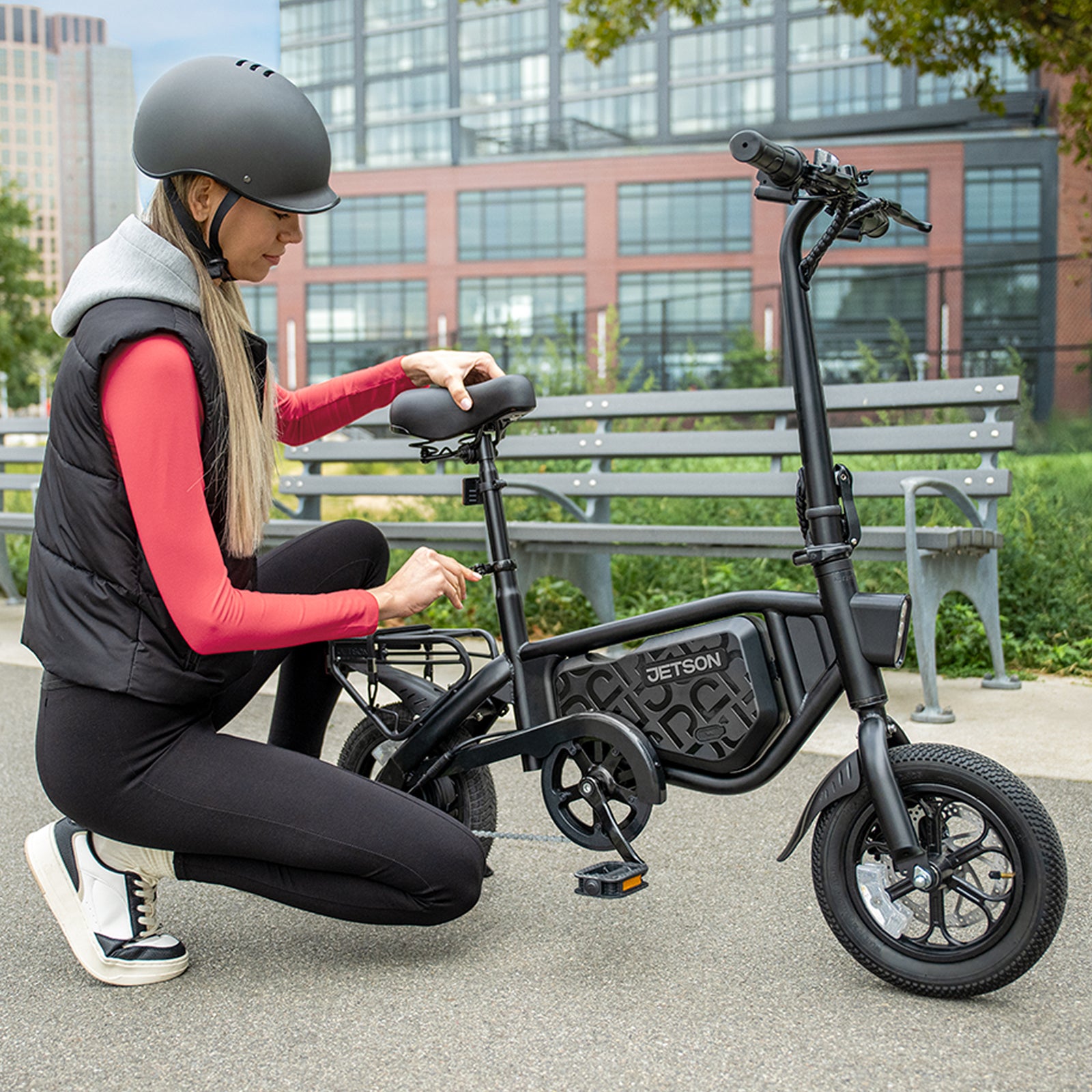 woman adjusting seat height on bolt pro x electric bike