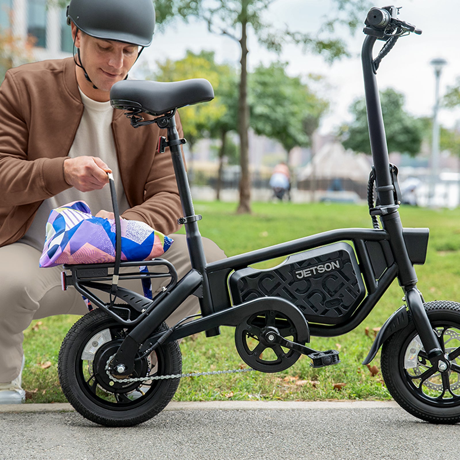 person securing package on rear bike rack on bolt pro x electric bike