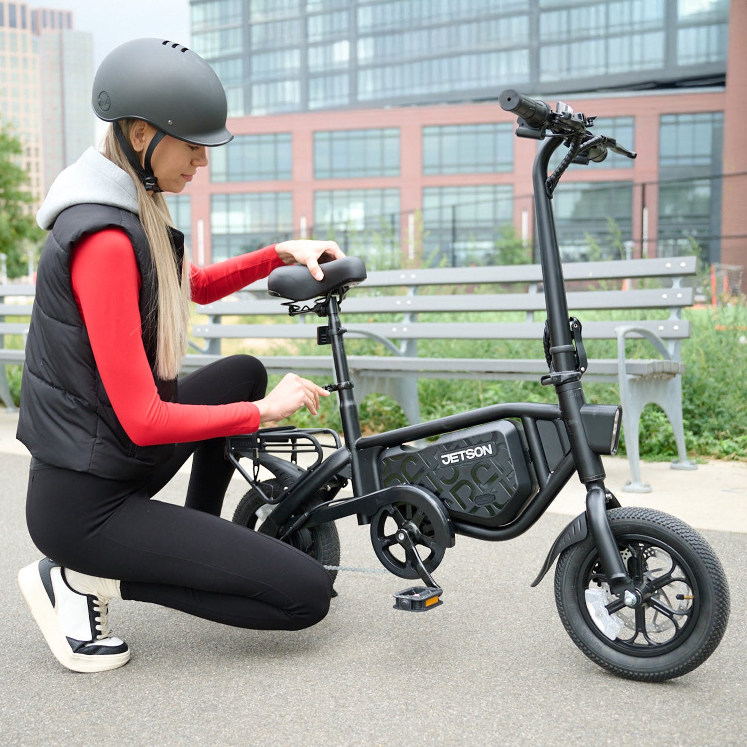 woman adjusting seat height on bolt pro x electric bike