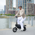 man riding bolt pro x electric bike by the water