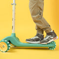 close up of a kids feet on the grogu customizable scooter