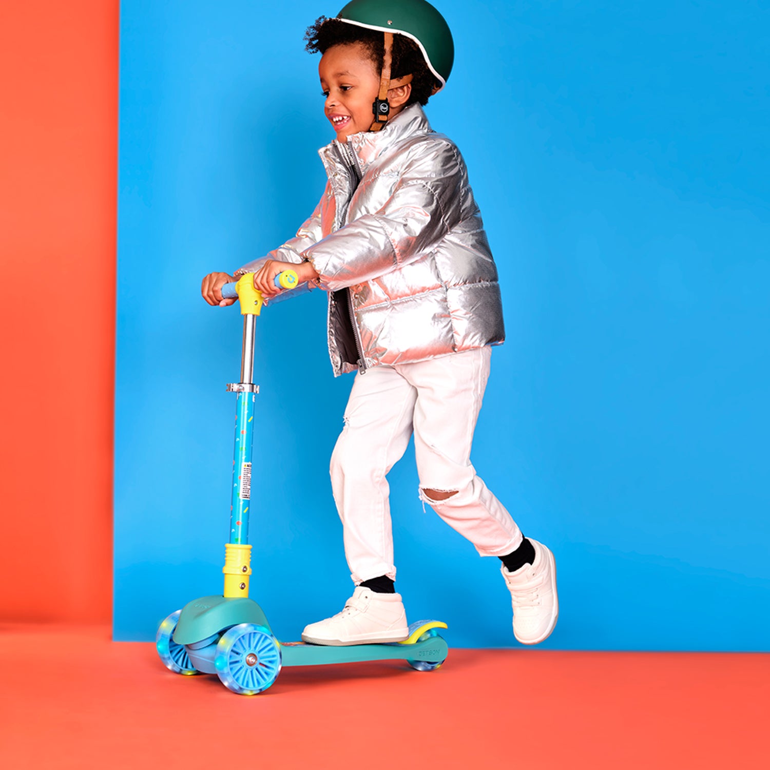 young kid riding cocomelon kick scooter