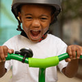 child holding onto handlebars featuring a bell