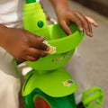 close up of child putting stickers on cocomelon light up trike
