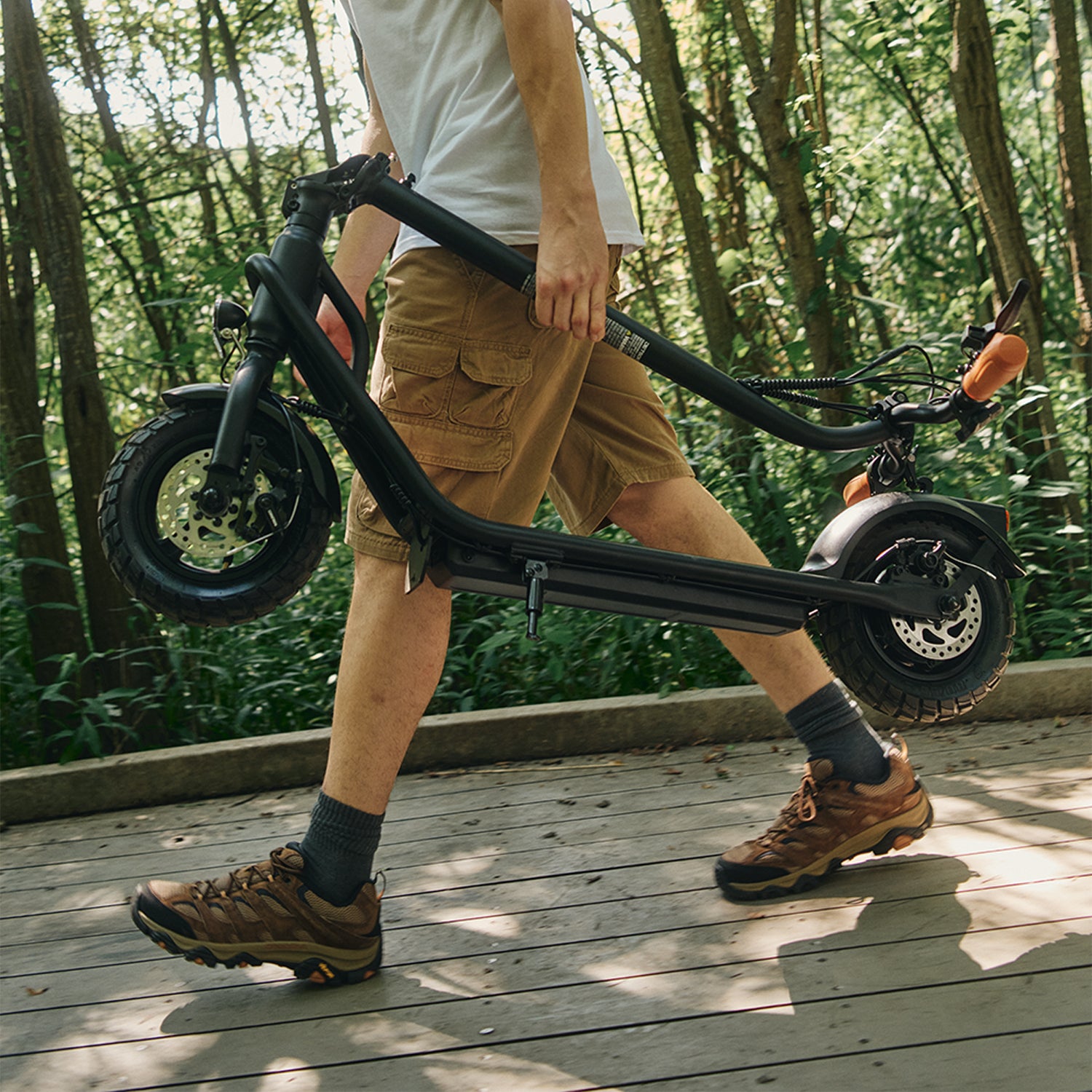 someone carrying a folded copperhead scooter