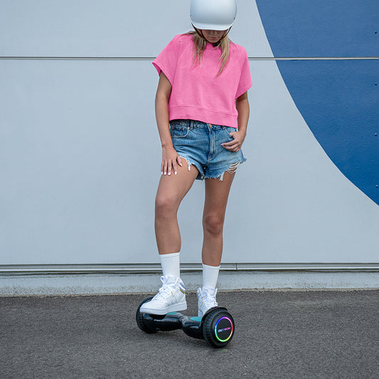 girl standing with one foot on dash hoverboard