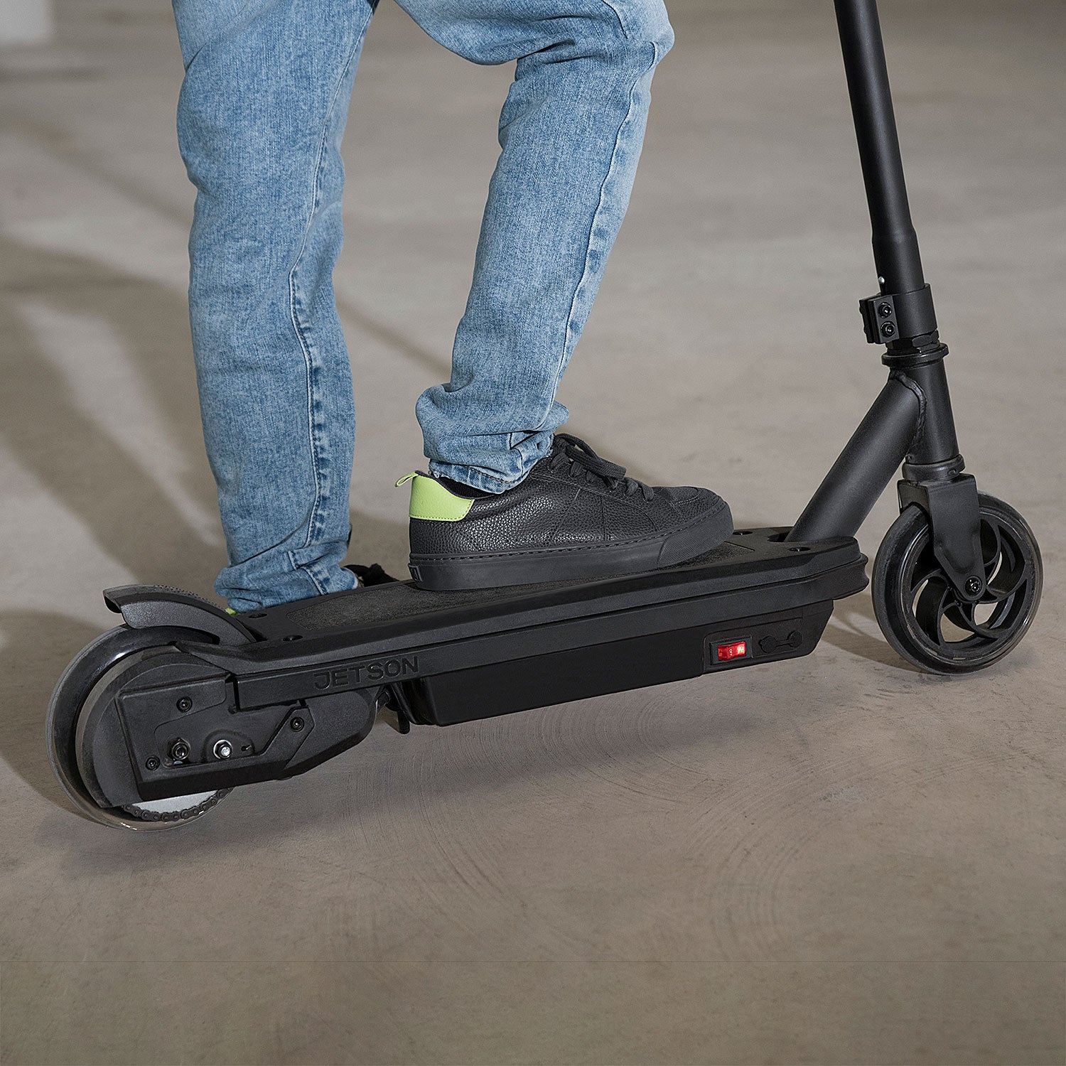 close up of a kid's foot resting on the echo electric scooter