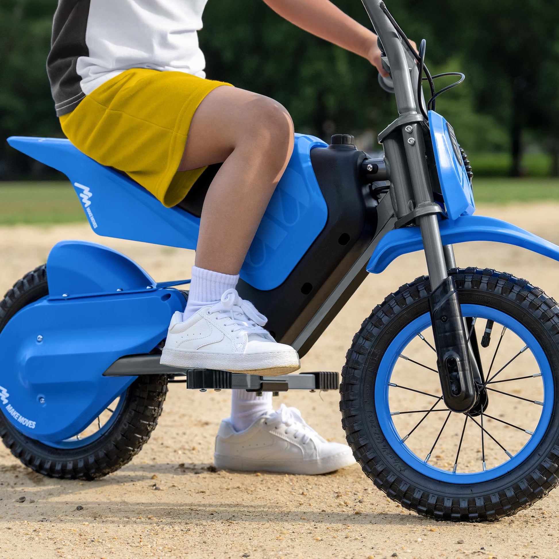 kid sitting on fort electric ride on with one foot resting on foot peg