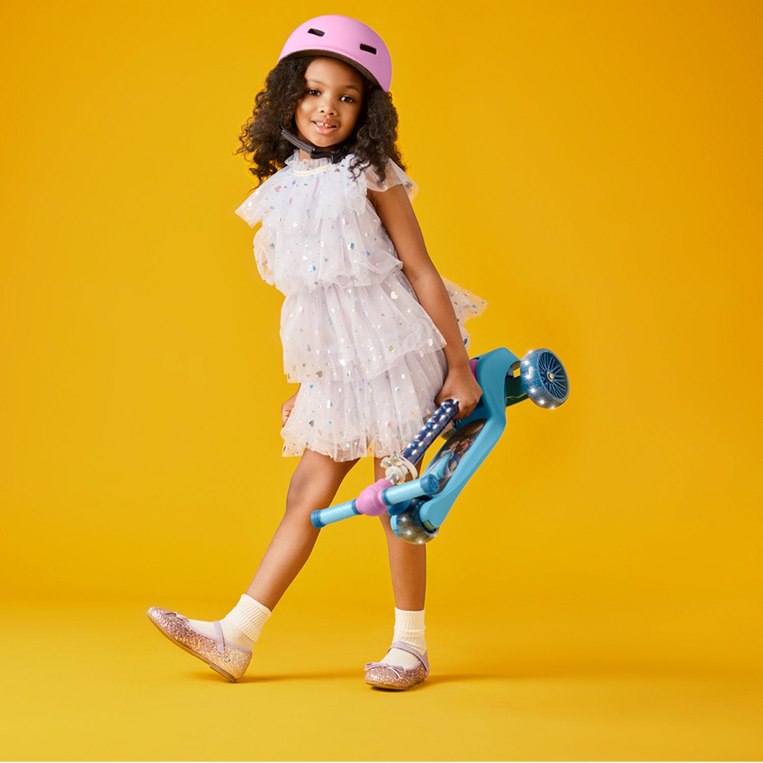 young girl holding a folded frozen kick scooter
