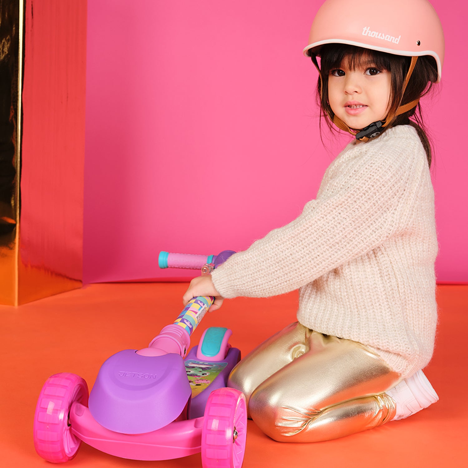 girl folding gabby's dollhouse kick scooter handlebar down