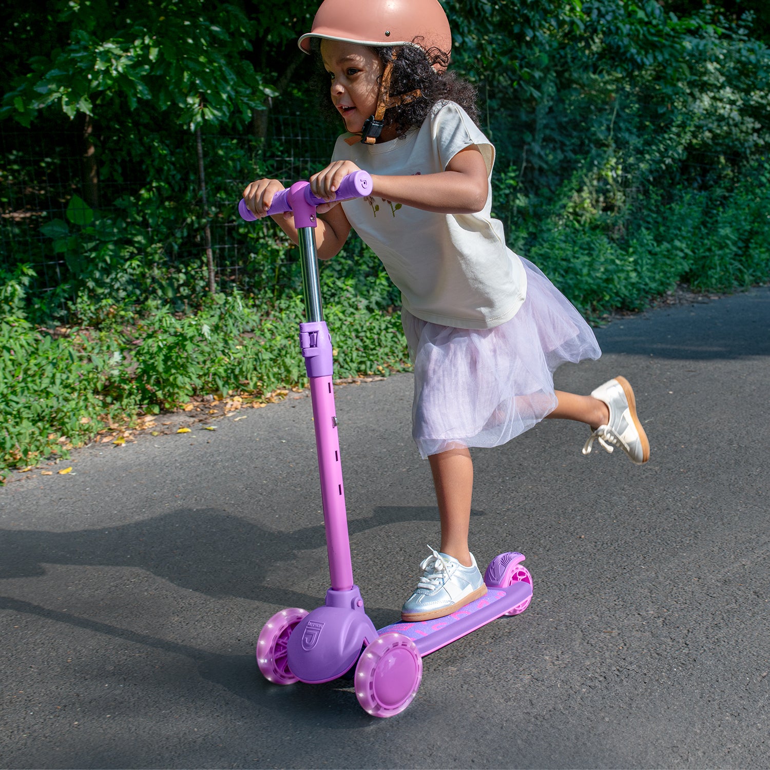 young girl riding gem kick scooter