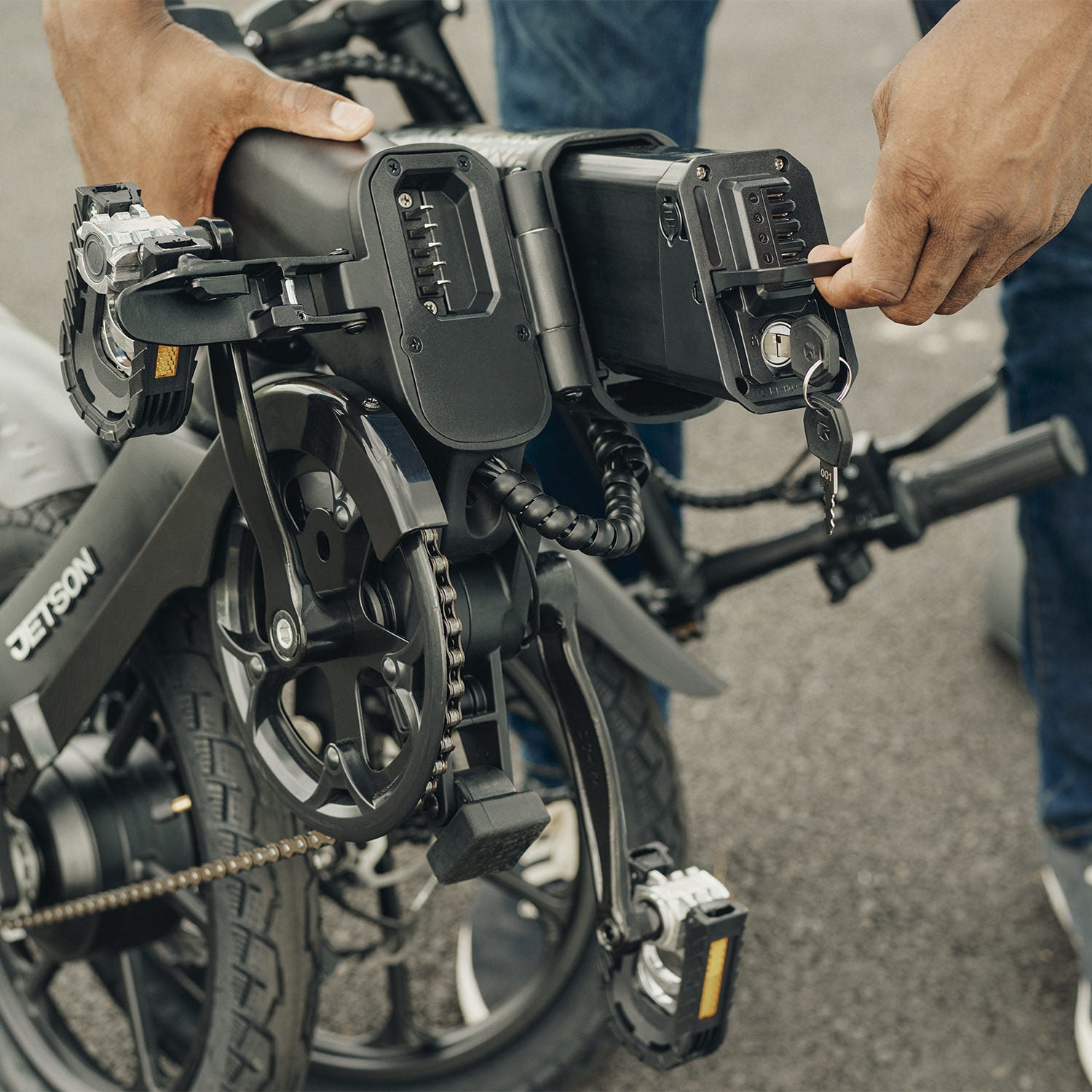 person removing the battery on the haze electric bike