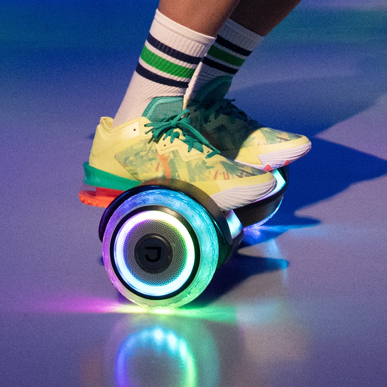 close up of a person riding the input hoverboard with the wheels lit up