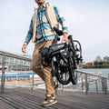 person carrying folded J8 bike