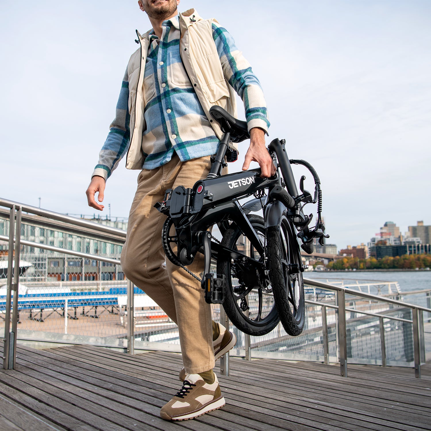 person carrying folded J8 bike