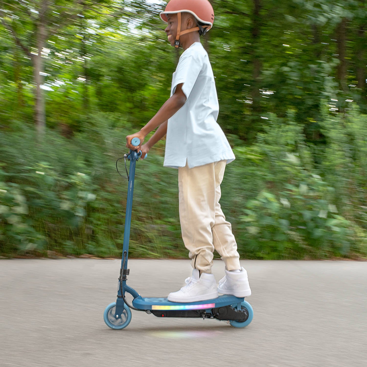 young kid riding blue electric scooter