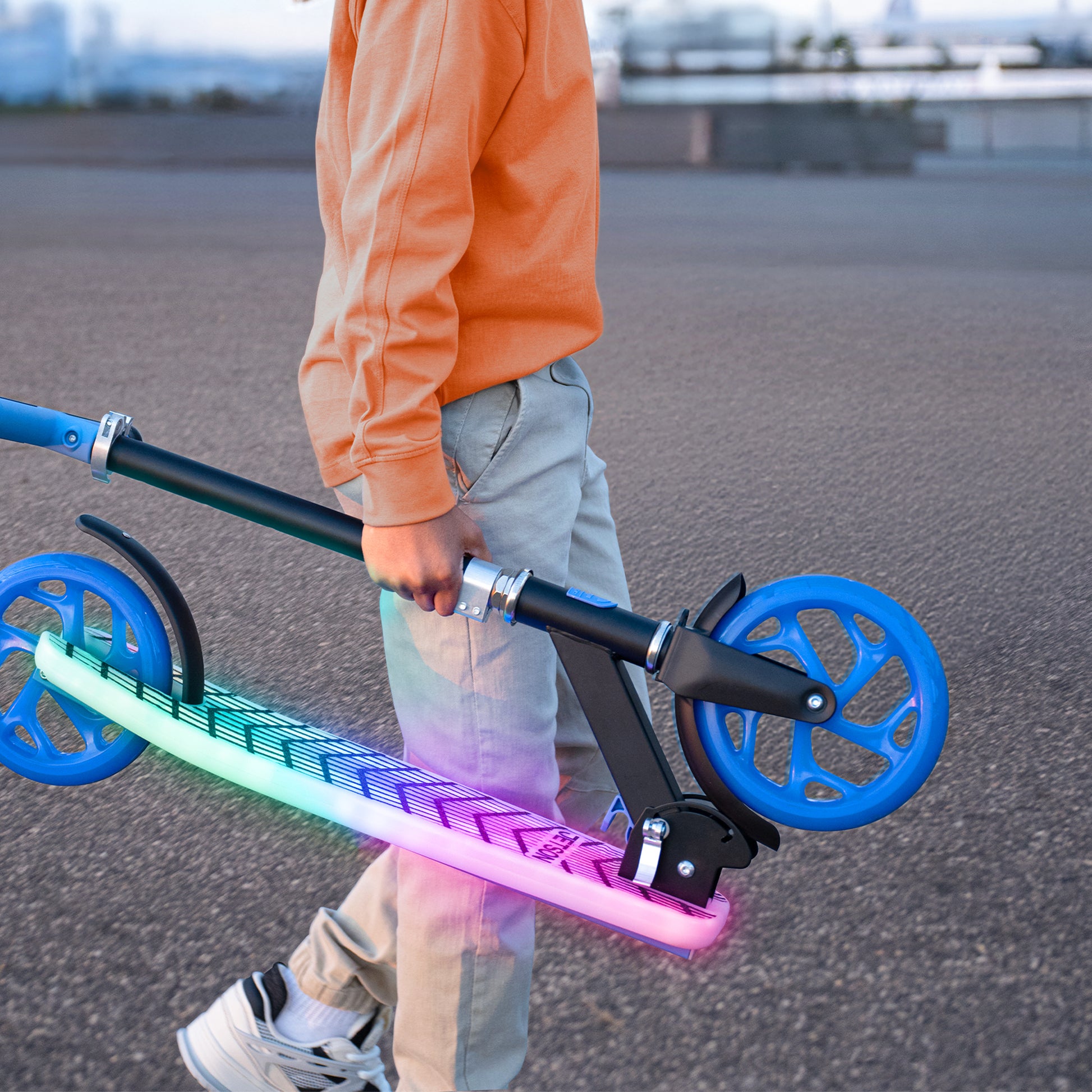 kid carrying folded J-Ray kick scooter