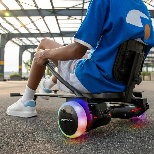 kid sitting on jetkart 3 attachment attached to a hoverboard
