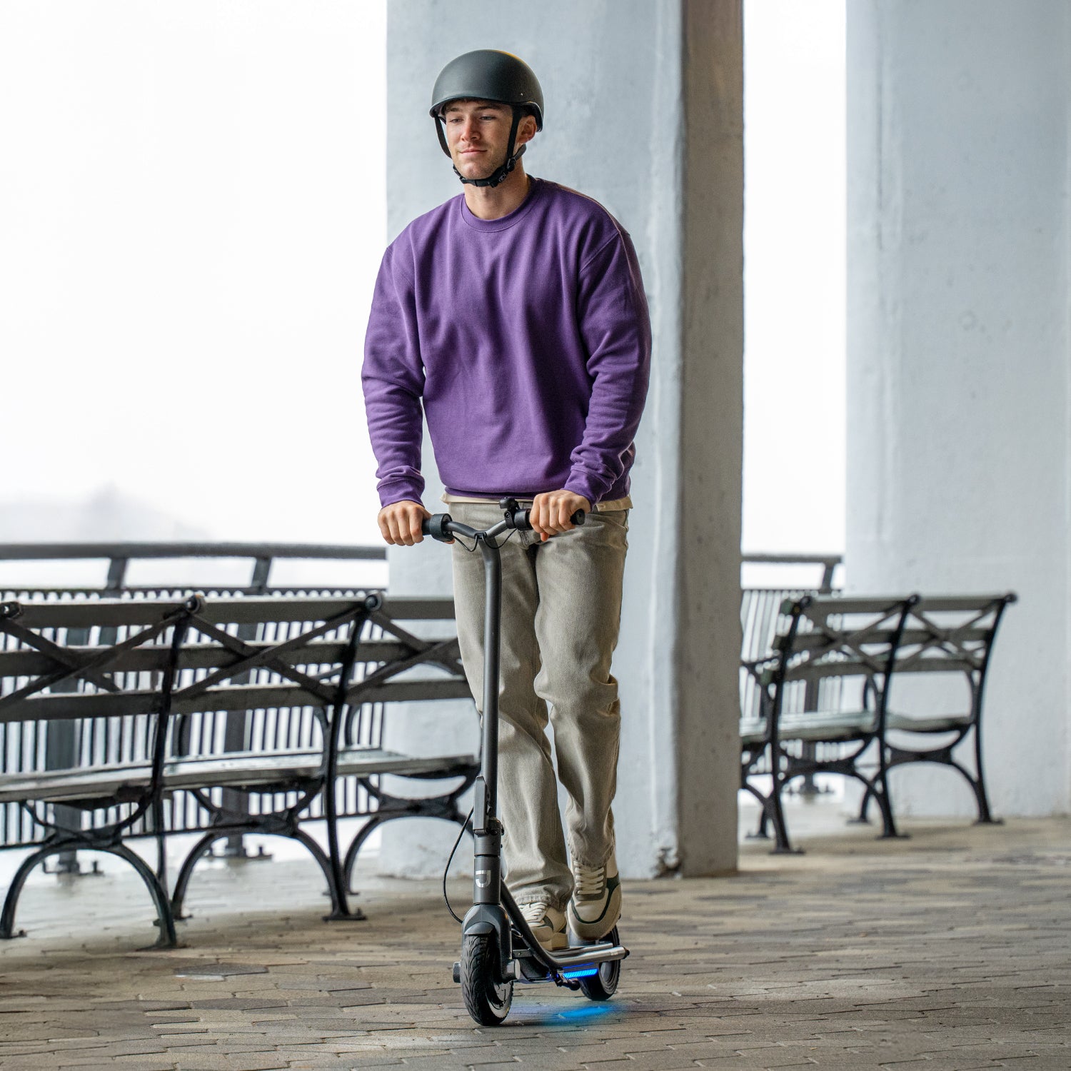 man riding loomis electric scooter