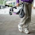 person carrying folded loomis electric scooter