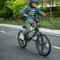 kid riding light rider bmx bike on a road