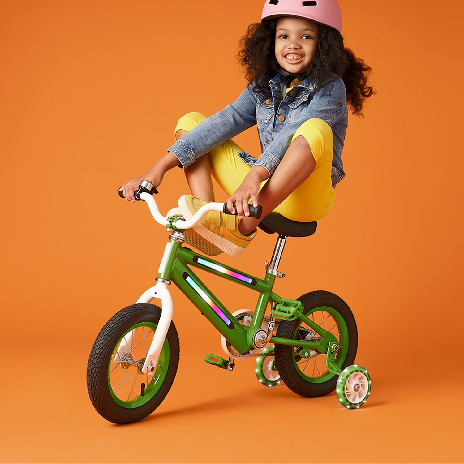 young kid riding green light up bike