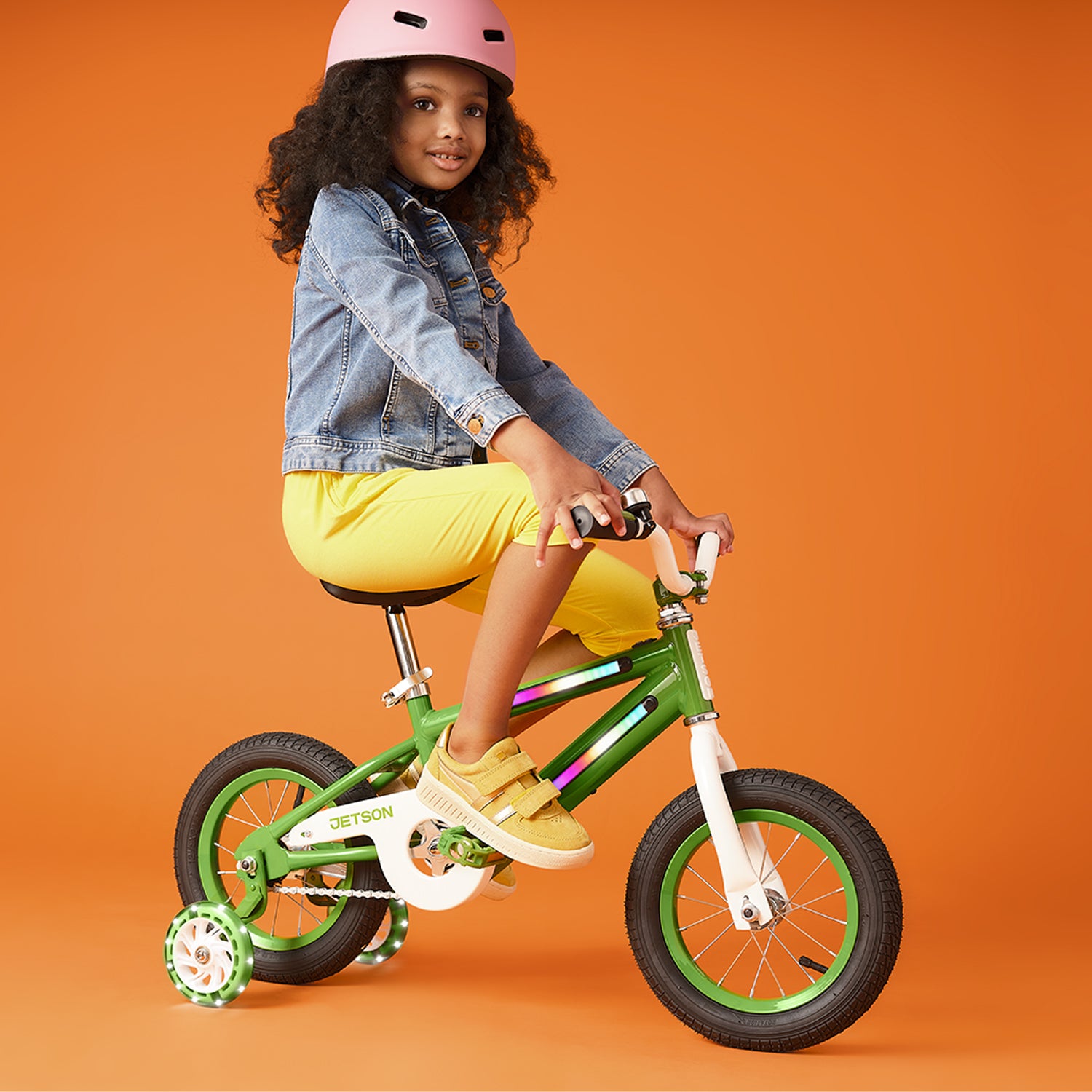 child with helmet riding light up kids bike